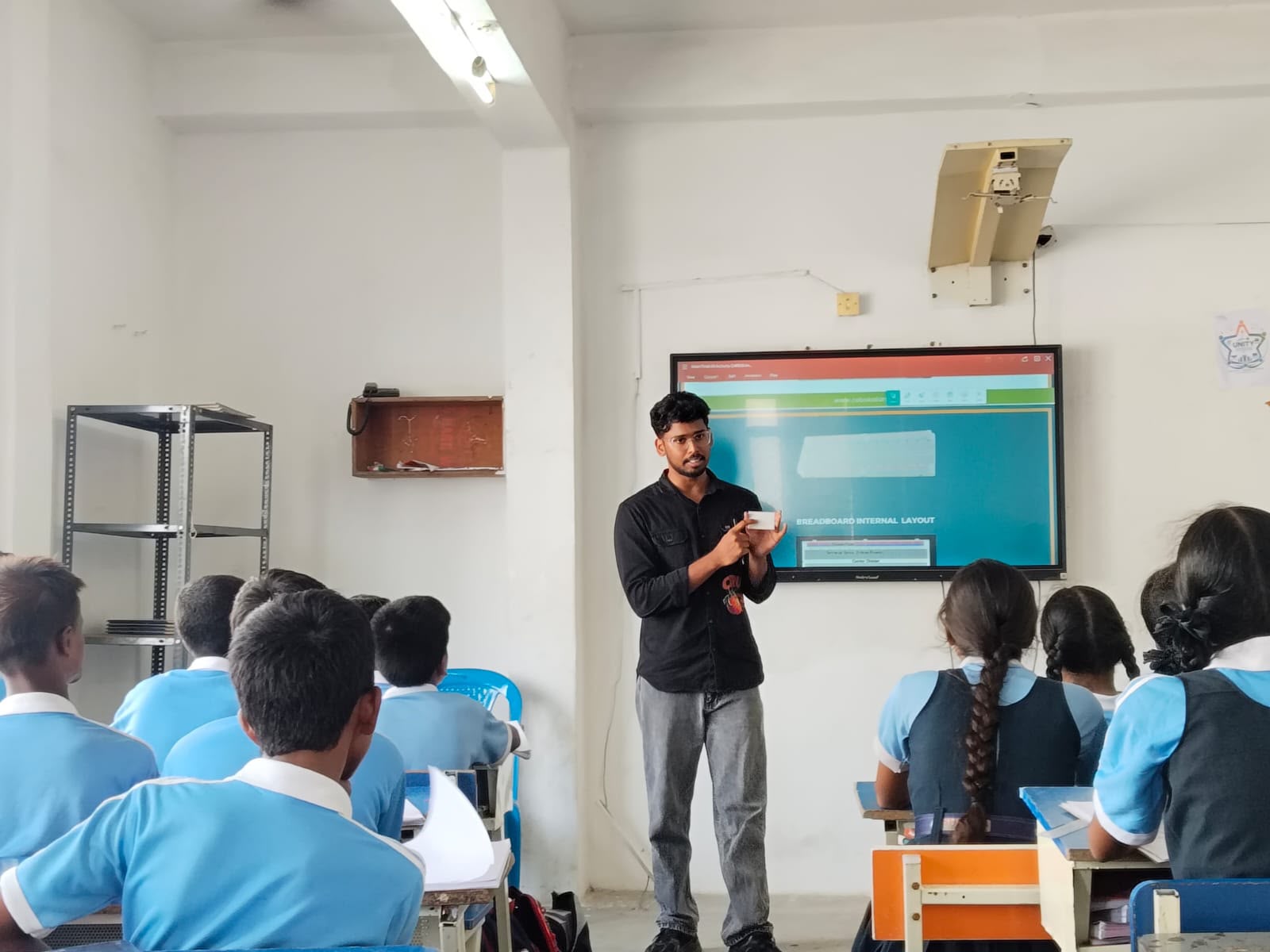 A Nxtera trainer demonstrating a breadboard component to students in the 21C Lab
