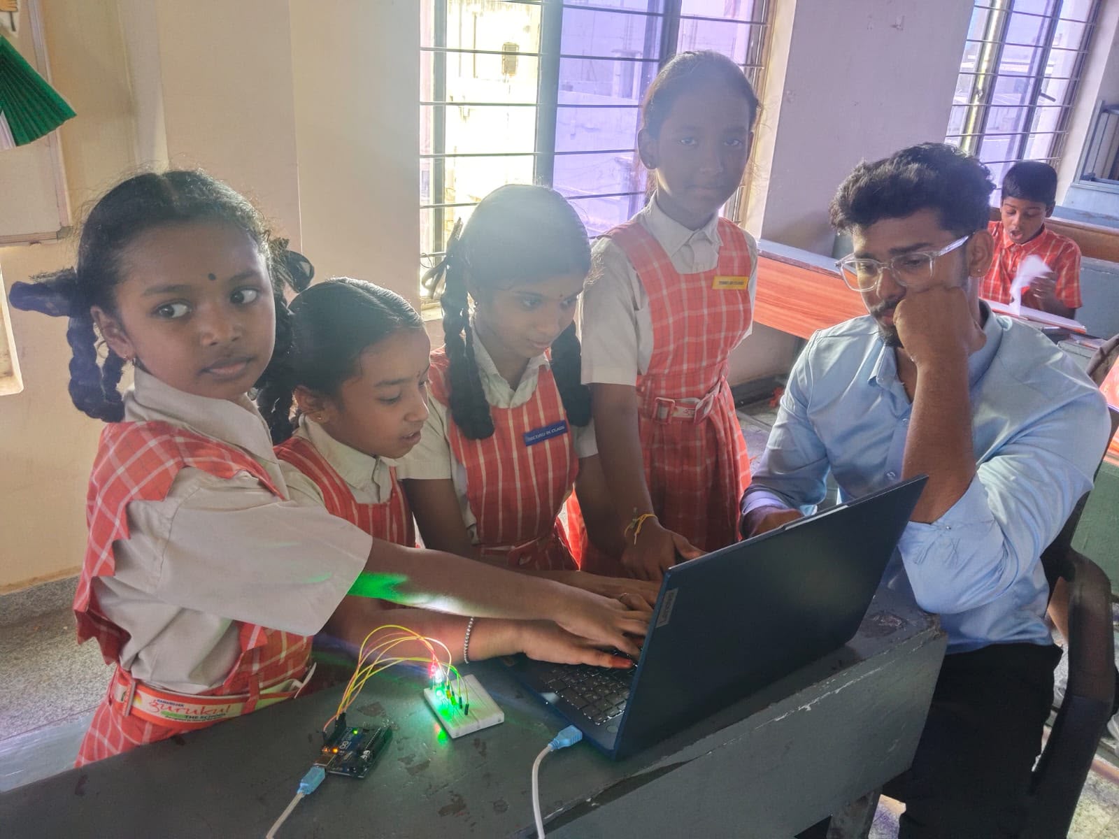 Young students building a glowing electronics project with a Nxtera trainer